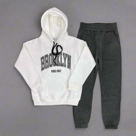White hoodie with Brooklyn Vibes Only print laid out with charcoal joggers