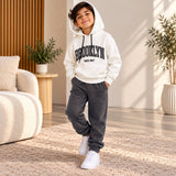 Brooklyn hoodie worn with charcoal joggers and white trainers, standing pose