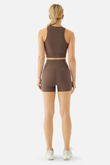 Person wearing a brown athletic outfit on a white background