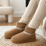 Brown winter boots with white trim worn indoors on a woven mat.