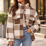 Woman wearing a brown and cream buffalo check sherpa shacket with flap chest pockets and jeans