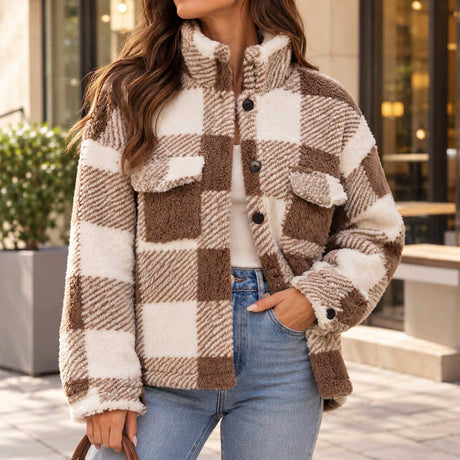 Woman wearing a brown and cream buffalo check sherpa shacket with flap chest pockets and jeans