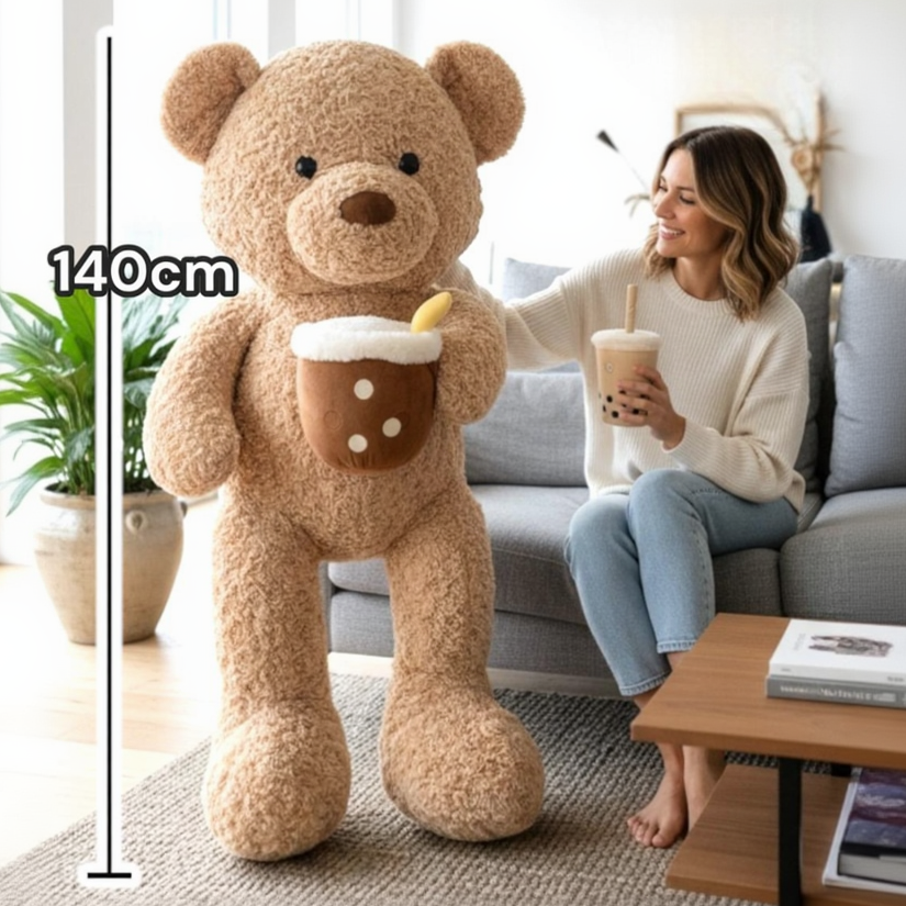 Caramel brown teddy bear beside a seated woman, with a 140cm measuring line