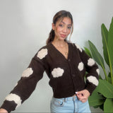 Brown cloud knit cardigan with one arm stretched out showing the cream cloud sleeve patches