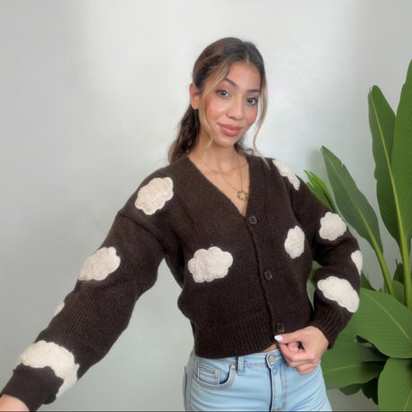 Brown cloud knit cardigan with one arm stretched out showing the cream cloud sleeve patches