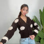 Brown cloud knit cardigan with one arm stretched out showing the cream cloud sleeve patches