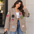 Woman in a brown houndstooth blazer covered in colourful embroidered patches with jeans