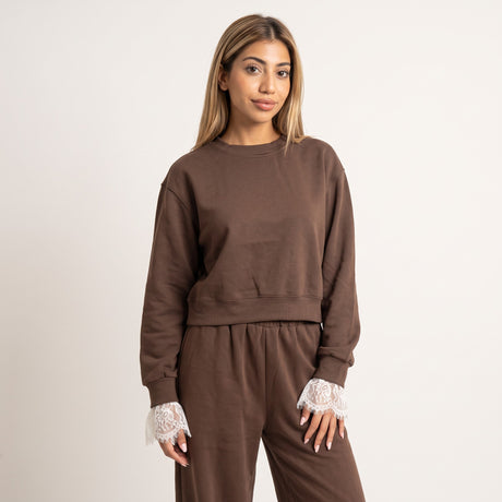 Cropped brown sweatshirt shown front on with lace trimmed sleeves