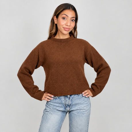 Rust brown cropped mock neck sweater with a ribbed hem, hands on hips with light jeans