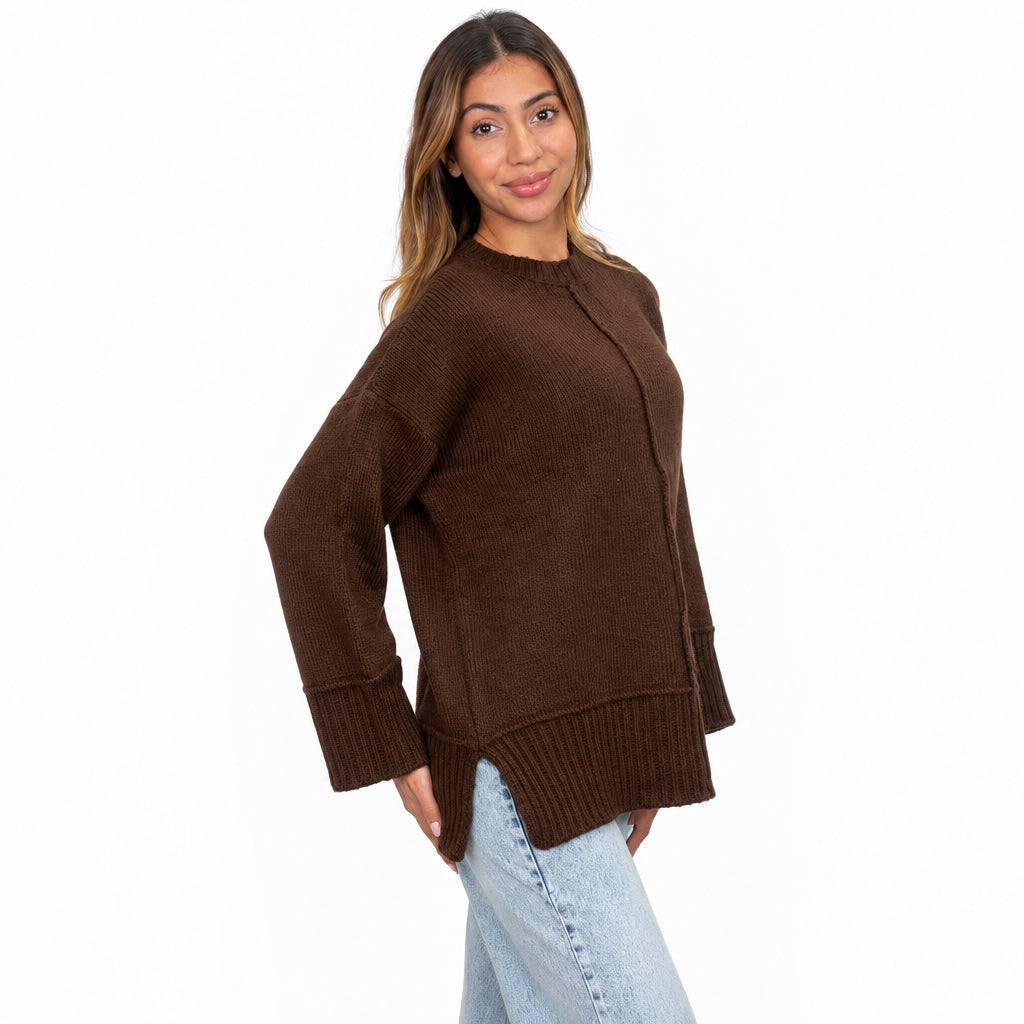 Brown oversized knit sweater with side slits and a centre seam, three quarter view