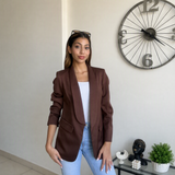 Warm brown jacket with the sleeves pushed up above the wrist
