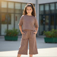Girl in a brown polka dot tee and matching wide leg culottes