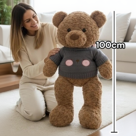 Caramel boucle teddy bear in a dark grey knit top, standing beside a 100cm measuring line