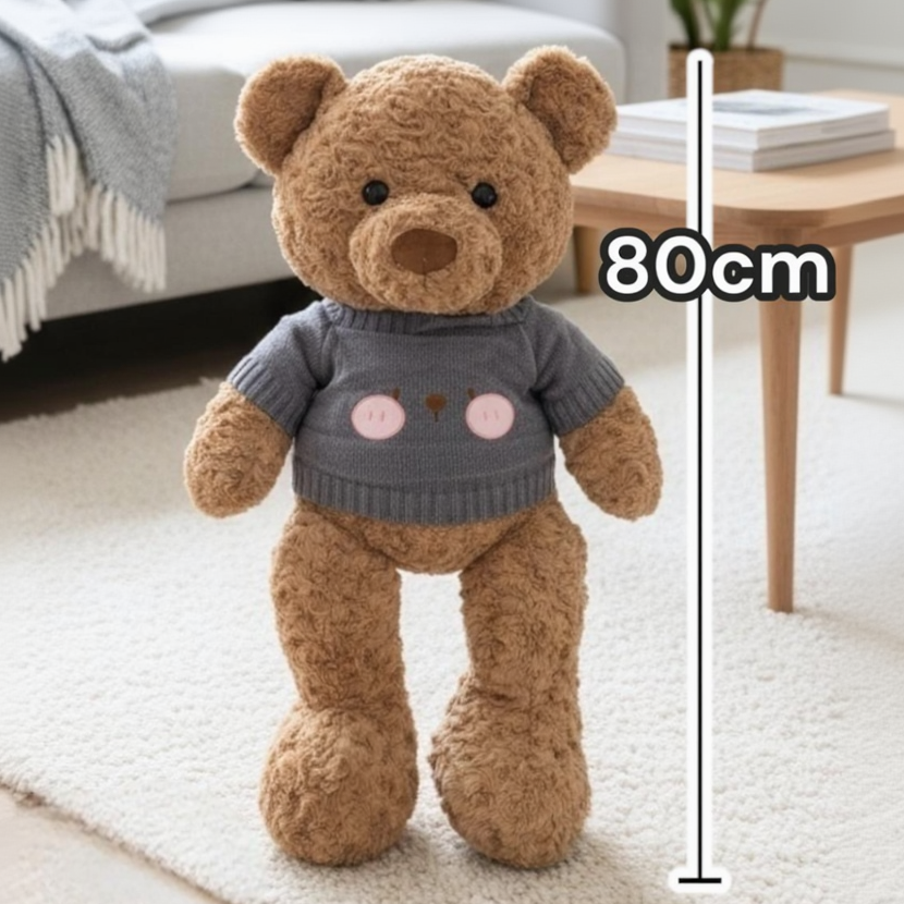 Golden brown teddy bear in a charcoal grey knit jumper with ribbed cuffs and hem