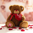 Honey brown shaggy bear with a red nose and satin bow hugging a frilled red heart
