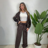 Brown velour hoodie worn open over a white crop top with matching drawstring wide leg pants