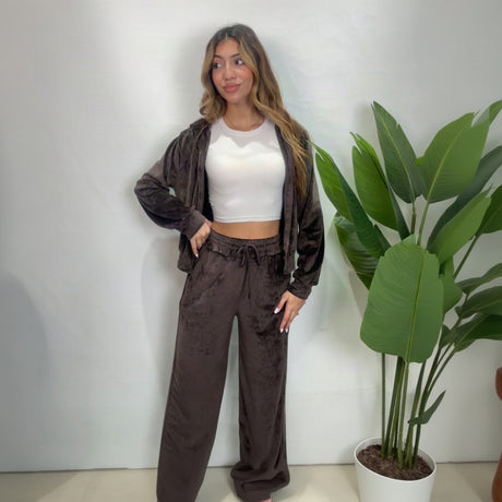Brown velour hoodie worn open over a white crop top with matching drawstring wide leg pants