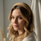 Brown woven headband worn by a person in warm sunlight