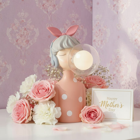 Coral polka dot figure with a grey blue bob, her globe lit against damask wallpaper