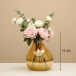 The smaller amber bubble vase marked 15 cm, holding peonies and white roses