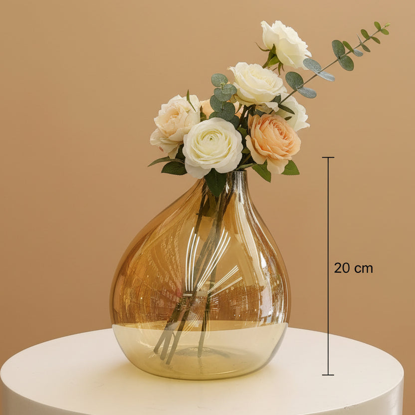 The larger amber bubble vase marked 20 cm with ranunculus and cream roses