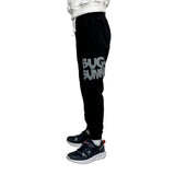 Back view of black kids joggers with a cartoon rabbit holding a basketball on the calf