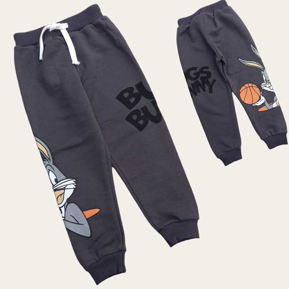 Flat lay of dark grey cartoon rabbit joggers with a white drawstring waist and ribbed ankles