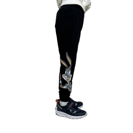 Side view close up of the grey cartoon rabbit printed on the lower leg of black joggers