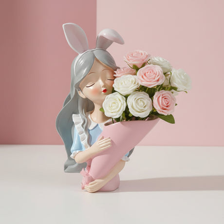 The bunny ear figure holding a fuller mix of cream and pale pink roses, plain backdrop