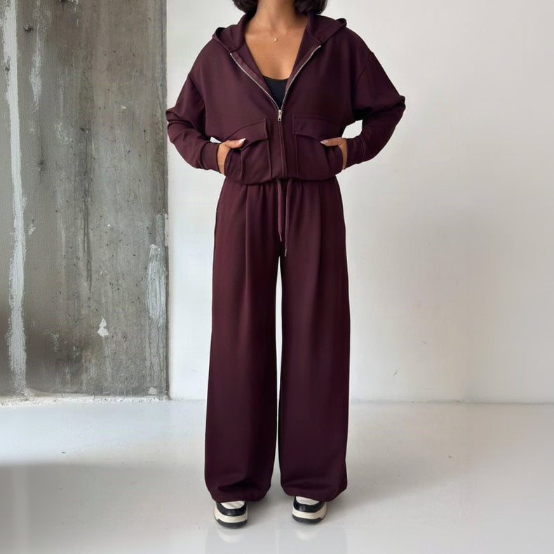 Full length view of the burgundy zip hoodie set showing the floor length wide leg trousers