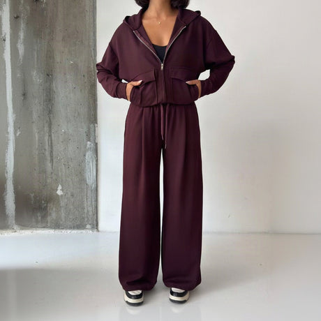 Full length view of the burgundy zip hoodie set showing the floor length wide leg trousers