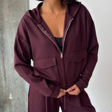 Women's burgundy zip hoodie with flap chest pockets and wide leg drawstring trousers