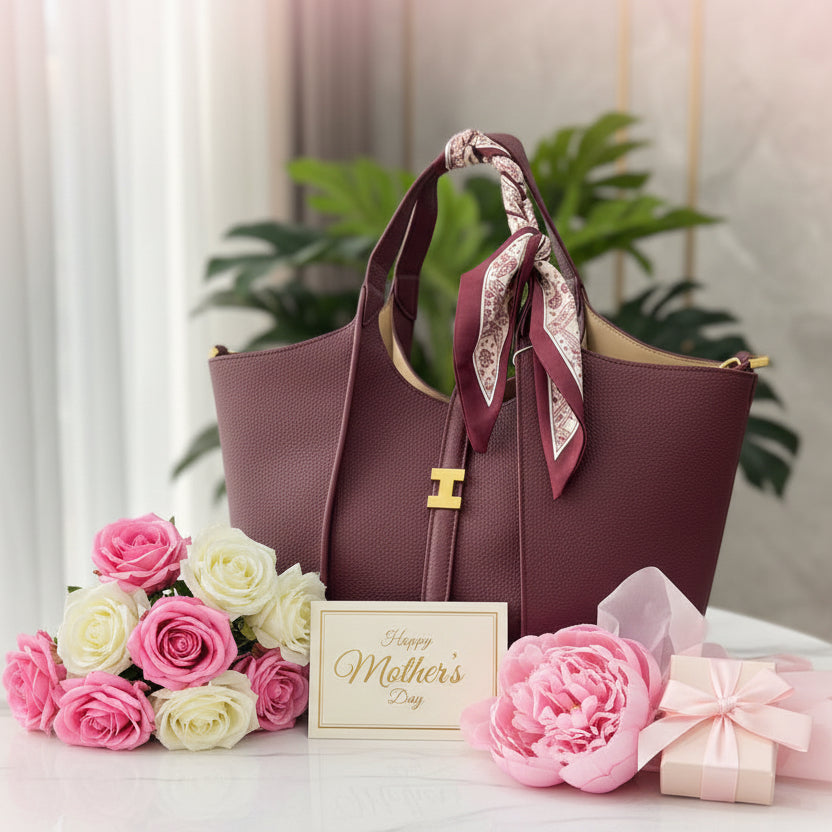 Burgundy handbag with a decorative bandana, pink and white roses and a Mother's Day card