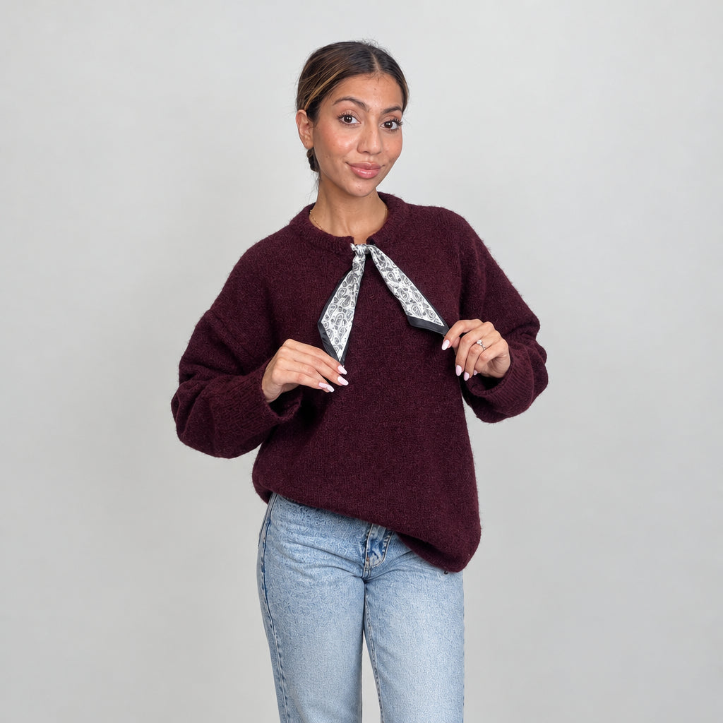 Burgundy wool knit top with a printed neck scarf tie, held at the ends