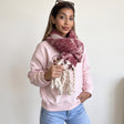 Deep burgundy scarf flecked with cream, knotted at the neck with thick rope fringe