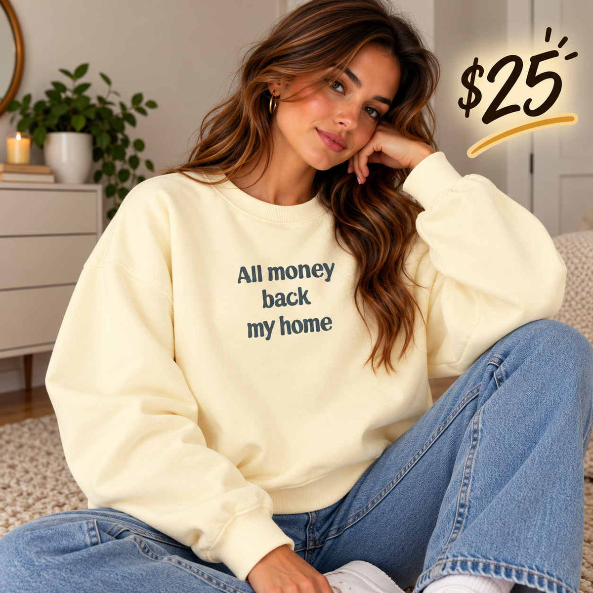 Woman in a butter yellow sweatshirt with an All Money Back My Home slogan print and light blue jeans