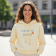 Woman in butter yellow hoodie with a blue and orange printed slogan, Jack Gifts Online Lebanon