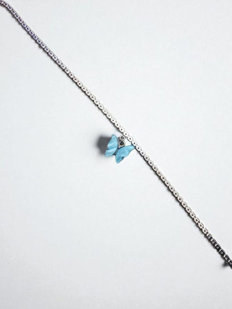 Close view of the blue butterfly charm on a silver chain