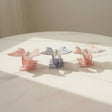 Butterfly claw clips in pink, cornflower blue, and white, with floral pastel prints
