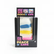 Rainbow layer cake slice sensory toy in black retail box, white squishy with blue, yellow and pink stripes