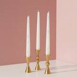 An hourglass, a single bead and a double bead holder in gold with white tapers