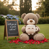 Mocha bear sitting on grass with the latte mug plush resting in its lap