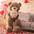 Mocha teddy bear with a cream muzzle hugging a giant smiling latte mug plush