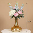 Amber decanter vase marked 20 cm holding peonies, hydrangea and blue delphinium