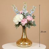 Amber decanter vase marked 20 cm holding peonies, hydrangea and blue delphinium