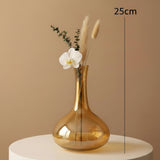 The taller decanter vase marked 25cm with a single white orchid and pampas stems