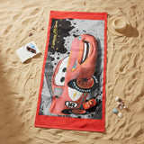 Red bordered Cars beach towel with a large Lightning McQueen print styled with a sun hat