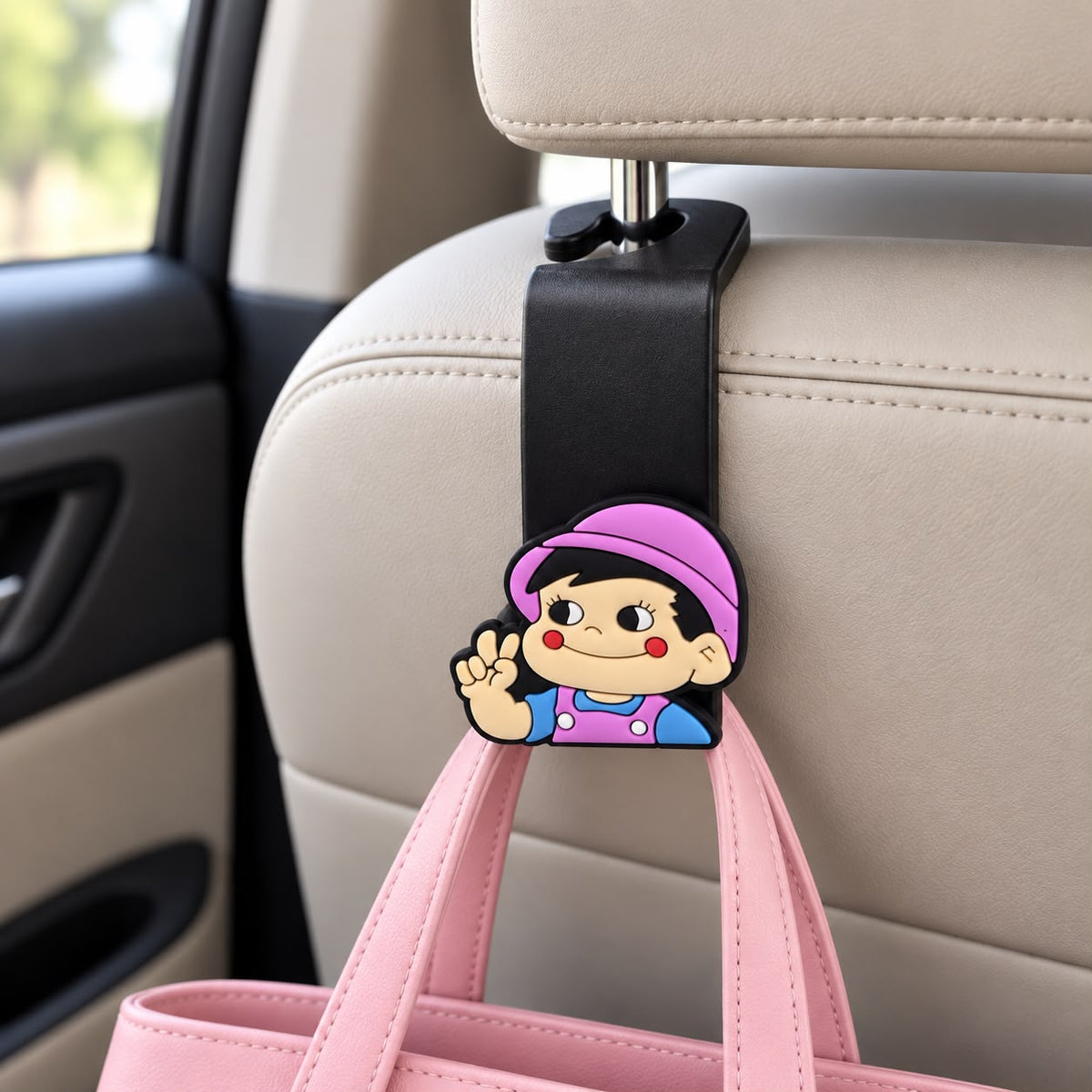 Car headrest hook with a cartoon girl topper in a pink cap and blue top holding a pink handbag