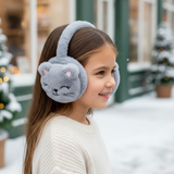 Grey plush cat face ear muffs with stitched whiskers worn by a girl in the snow