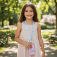 Girl in a pink dress holding a pink cat card wallet clipped to a blue printed neck lanyard